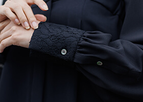 レース袖と貝ボタンのさりげないアクセント